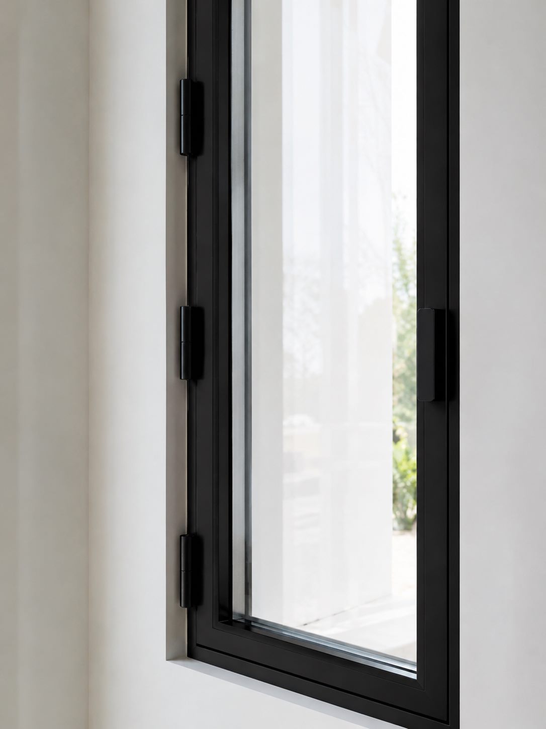 Close-up detail of casement window hinges and aluminum frame